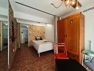 a bedroom with a bed and a red chair at Artistic Atelier, Top Center - Vitosha Blvd in Sofia