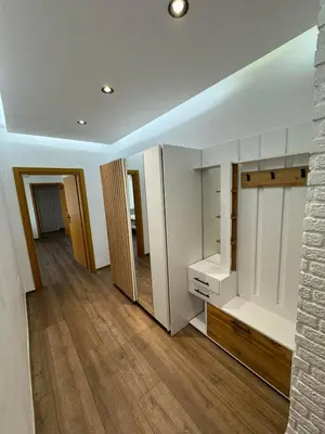 a room with white cabinets and a wooden floor at Апартамент LiAn in Plovdiv