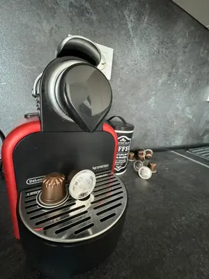 a black and red coffee maker with a muffin in it at Апартамент LiAn in Plovdiv