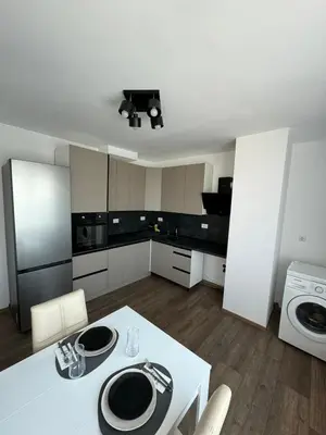 a kitchen with a white table and white appliances at Апартамент LiAn in Plovdiv