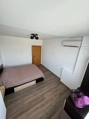 a small room with a bed and a window at Апартамент LiAn in Plovdiv