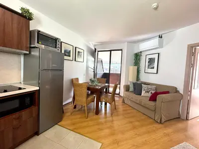 a kitchen and living room with a couch and a table at Bansko&Ski in Bansko