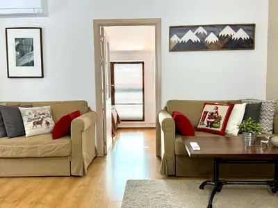 a living room with two couches and a table at Bansko&Ski in Bansko