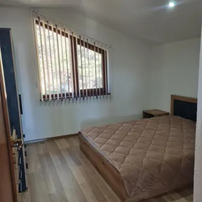 a bedroom with a large bed and a window at Вила Хадживезула in Yokoruda