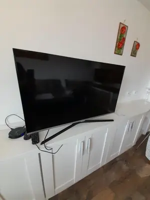 a flat screen tv sitting on top of a white cabinet at Belvedere Holiday Club H79 in Bansko