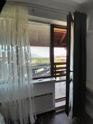 a room with a window with a view of a balcony at Belvedere Holiday Club H79 in Bansko