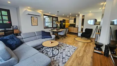 a living room with a couch and a table at MONTEVERDE Tamplier in Bansko