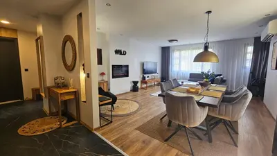 a dining room and living room with a table and chairs at MONTEVERDE Tamplier in Bansko