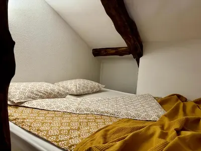 a bed with two pillows on top of it at Туйковата къща The Tuikov House in Teteven