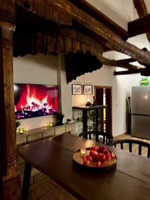 a table with a plate of fruit in front of a fireplace at Туйковата къща The Tuikov House in Teteven