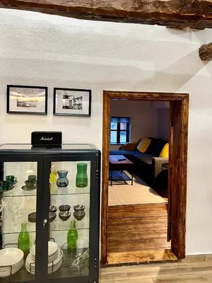 a room with a glass cabinet with dishes in it at Туйковата къща The Tuikov House in Teteven