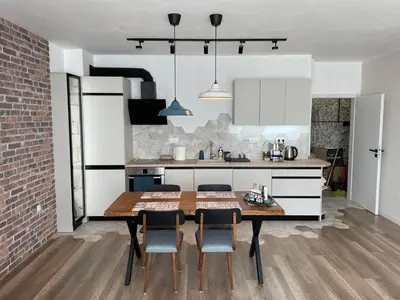 a kitchen with a table and chairs in a room at Platinum Luxury Industrial Unit City-Center in Plovdiv