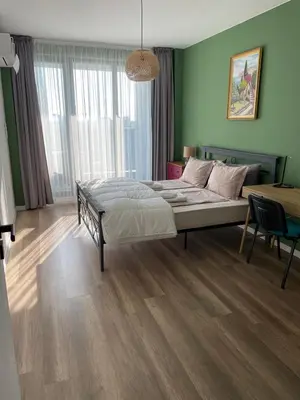 a bedroom with a bed in a room with green walls at Platinum Luxury Industrial Unit City-Center in Plovdiv