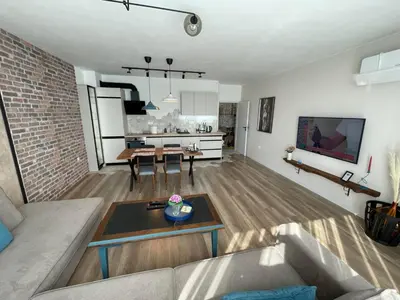 a living room with a couch and a table at Platinum Luxury Industrial Unit City-Center in Plovdiv