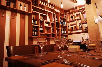 a table in a restaurant with wine glasses on it at GS SKI Apartment - The Grand Monastery Pamporovo in Pamporovo
