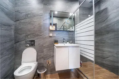 a bathroom with a toilet and a sink at Getaway 2 Bedroom Dream Apartment - free parking in Bansko