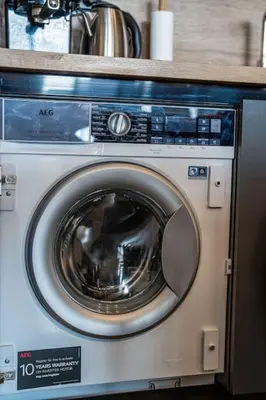 a washing machine is sitting in a kitchen at Getaway 2 Bedroom Dream Apartment - free parking in Bansko