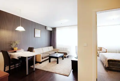 a living room with a couch a table and a bed at Apartments Carrera in Sofia