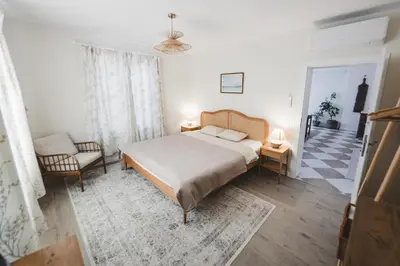 a bedroom with a bed and a chair at Newly Built Family Villa with a Hot Tub in Sopot