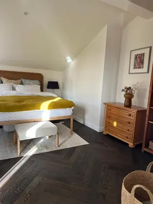 a bedroom with a bed and a wooden dresser at Newly Built Family Villa with a Hot Tub in Sopot