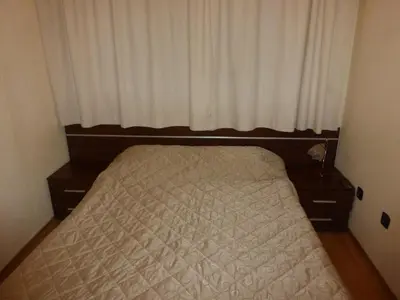 a small bedroom with a bed with a window at Two-Bedroom Apartment in Fortuna in Bansko