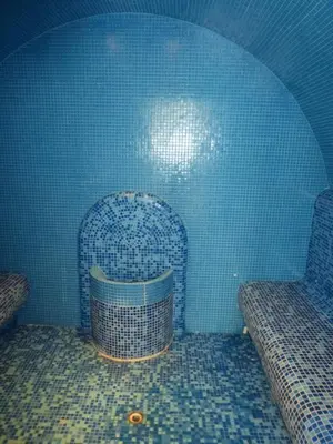 a room with two chairs and a blue wall at Two-Bedroom Apartment in Fortuna in Bansko