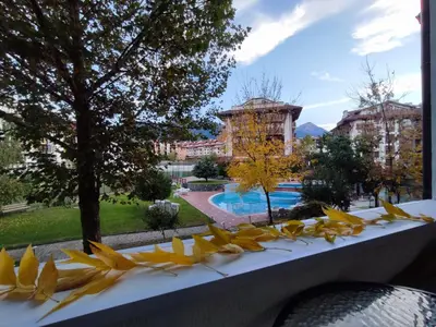 a view from the balcony of a resort with yellow flowers at Belvedere Holiday Club 2Bedroom Apartment F201 in Bansko