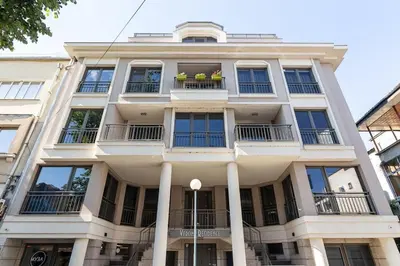 a white building with windows and balconies at Center Apt - Free parking - Walk to Main Street in Plovdiv