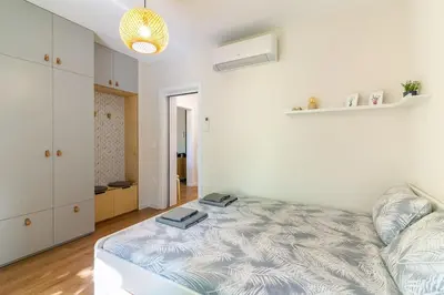 a bedroom with a bed with two books on it at Center Apt - Free parking - Walk to Main Street in Plovdiv