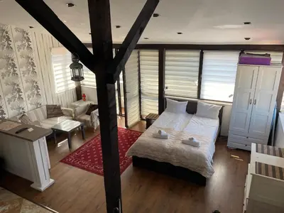a bedroom with a bed and a living room at Kapana Plovdiv in Plovdiv