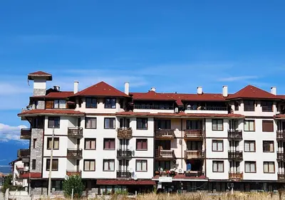 a large white building with a red roof at 