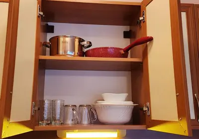 a cabinet filled with dishes and utensils at 
