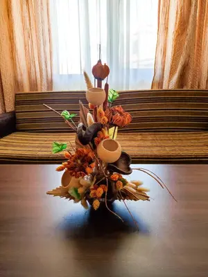 a vase filled with flowers and mushrooms on a table at Dream 1BRoom Private Apartment in Bansko