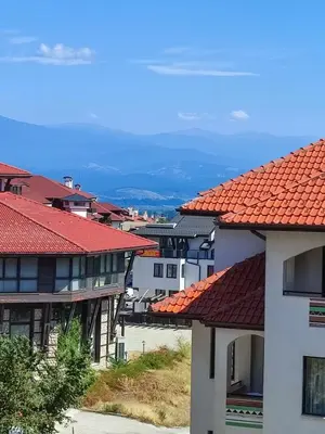 a group of buildings with red tile roofs at Dream 1BRoom Private Apartment in Bansko
