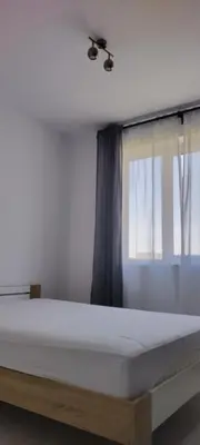 a bed in a room with a window at O pulse Sofia apartment in Sofia