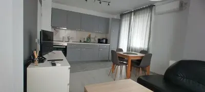 a kitchen and living room with a table and chairs at O pulse Sofia apartment in Sofia