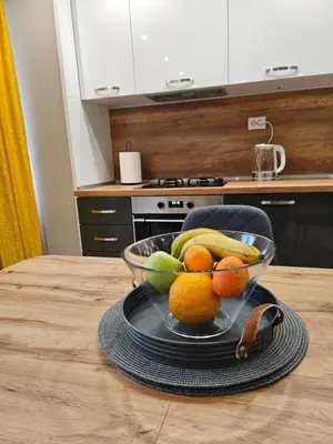 a bowl of fruit on a table in a kitchen at Boutique apartment yellow 1 in Plovdiv