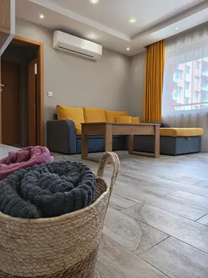 a living room with a couch and a basket at Boutique apartment yellow 1 in Plovdiv