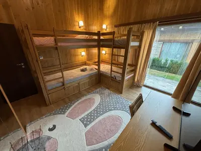 a room with two bunk beds with a rabbit on the floor at Villa Pirin Golf in Bansko