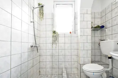 a white bathroom with a toilet and a shower at Creative 70s-Inspired Stay Center Parking in Sofia