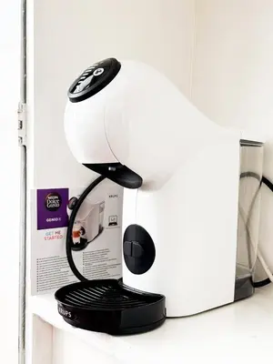 a white and black mixer sitting on a shelf at Creative 70s-Inspired Stay Center Parking in Sofia