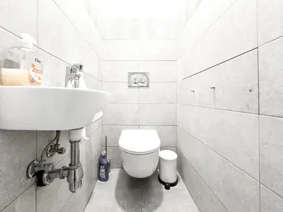 a white bathroom with a sink and a toilet at Prime Spot - 2BR -15BTH - Next to Nevsky Church in Sofia