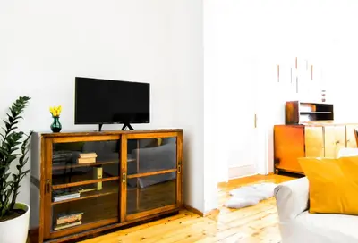 a living room with a television on top of a cabinet at Prime Spot - 2BR -15BTH - Next to Nevsky Church in Sofia