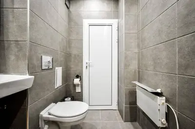 a bathroom with a toilet and a sink at Work Friendly 2BR AC Terrace Str Parking in Sofia