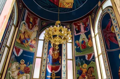 a chandelier in a church with paintings on the ceilings at Апартамент в Лъки Пампорово комплекс in Pamporovo