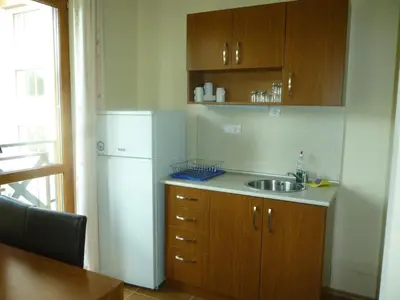 a kitchen with a sink and a refrigerator at Апартамент в Лъки Пампорово комплекс in Pamporovo