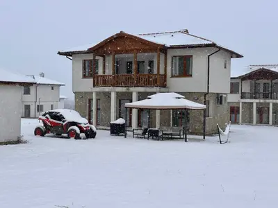 a car parked in a parking lot in front of a house at Villa Vista in Dolna Banya