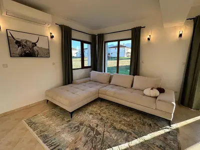 a living room with a couch and a large window at Villa Vista in Dolna Banya