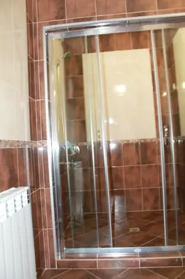 a shower with a glass door in a bathroom at Leshtenski Perli in Leshten