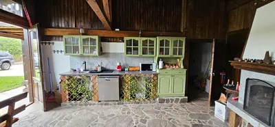 a kitchen with green cabinets and a stove at Къща за гости Имало едно време in Smolyan